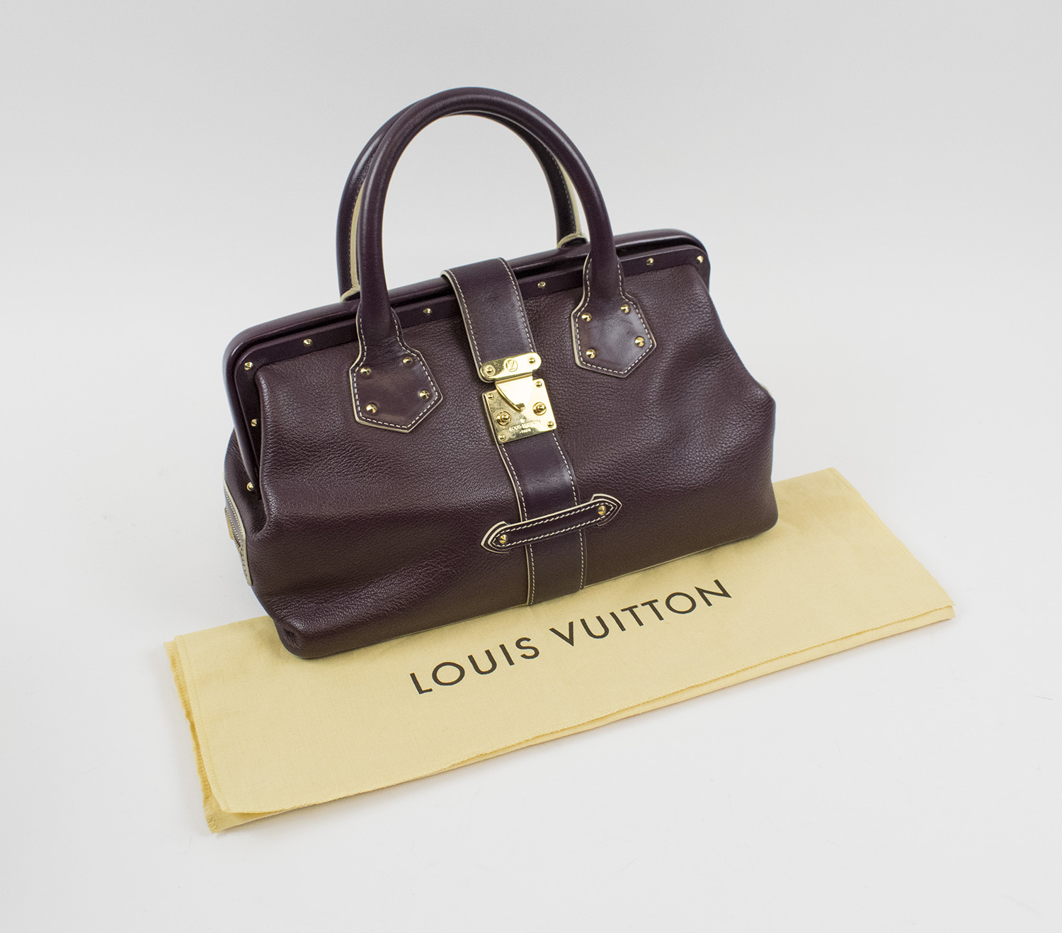LOUIS VUITTON L'INGENIEUX BAG IN PRUNE SUHALI LEATHER, two top handles,  gold tone hardware with square bottom feet, flap tab with S-lock closure,  prune fabric lining with micro monogram, two small zip