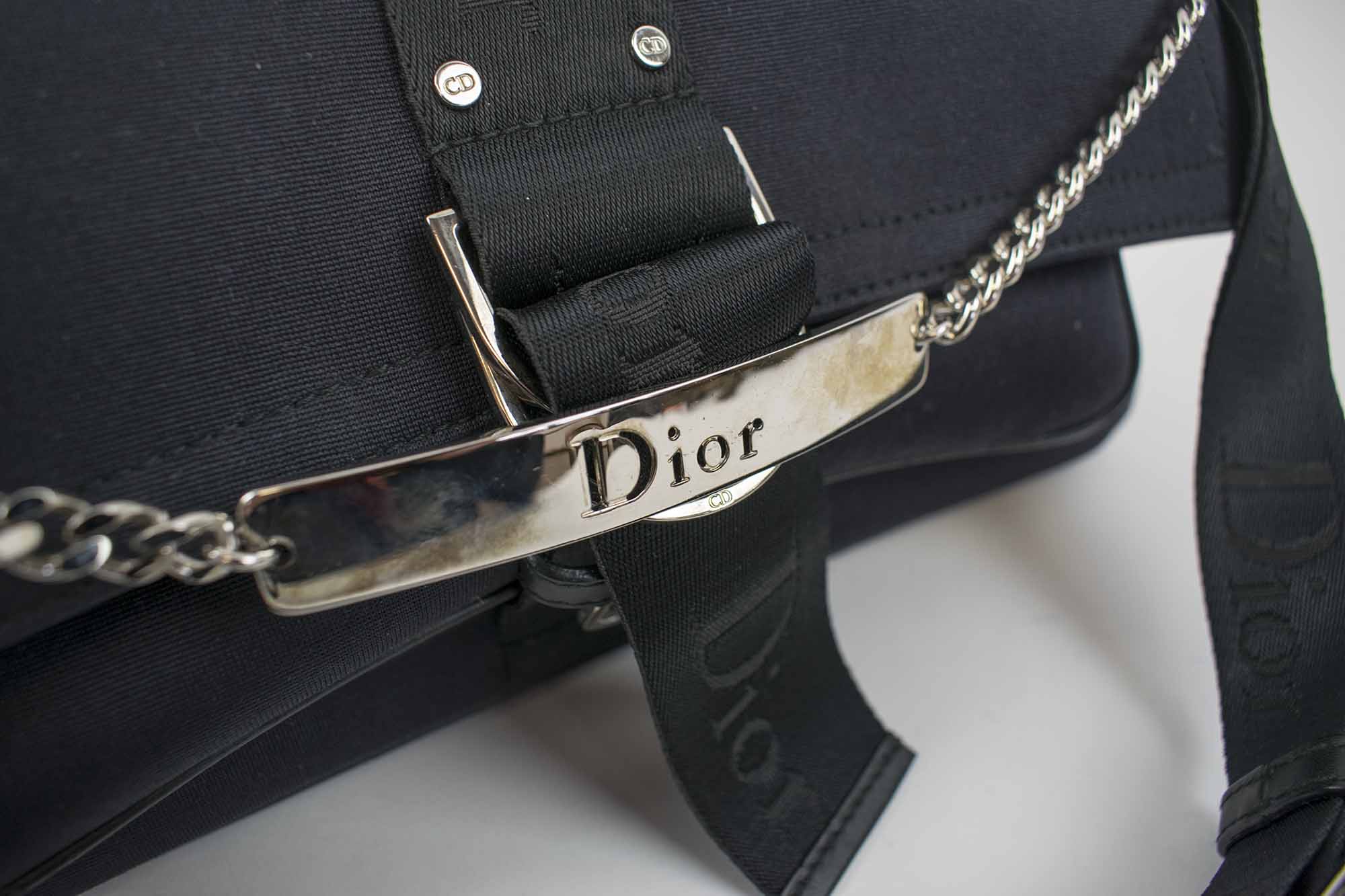 CHRISTIAN DIOR SATIN BAG, black satin with logo on the strap and front,  monogram fabric lining, removable rhinestone clasp and silver link chain,  bottom feet, 31cm x 15cm H x 8cm.