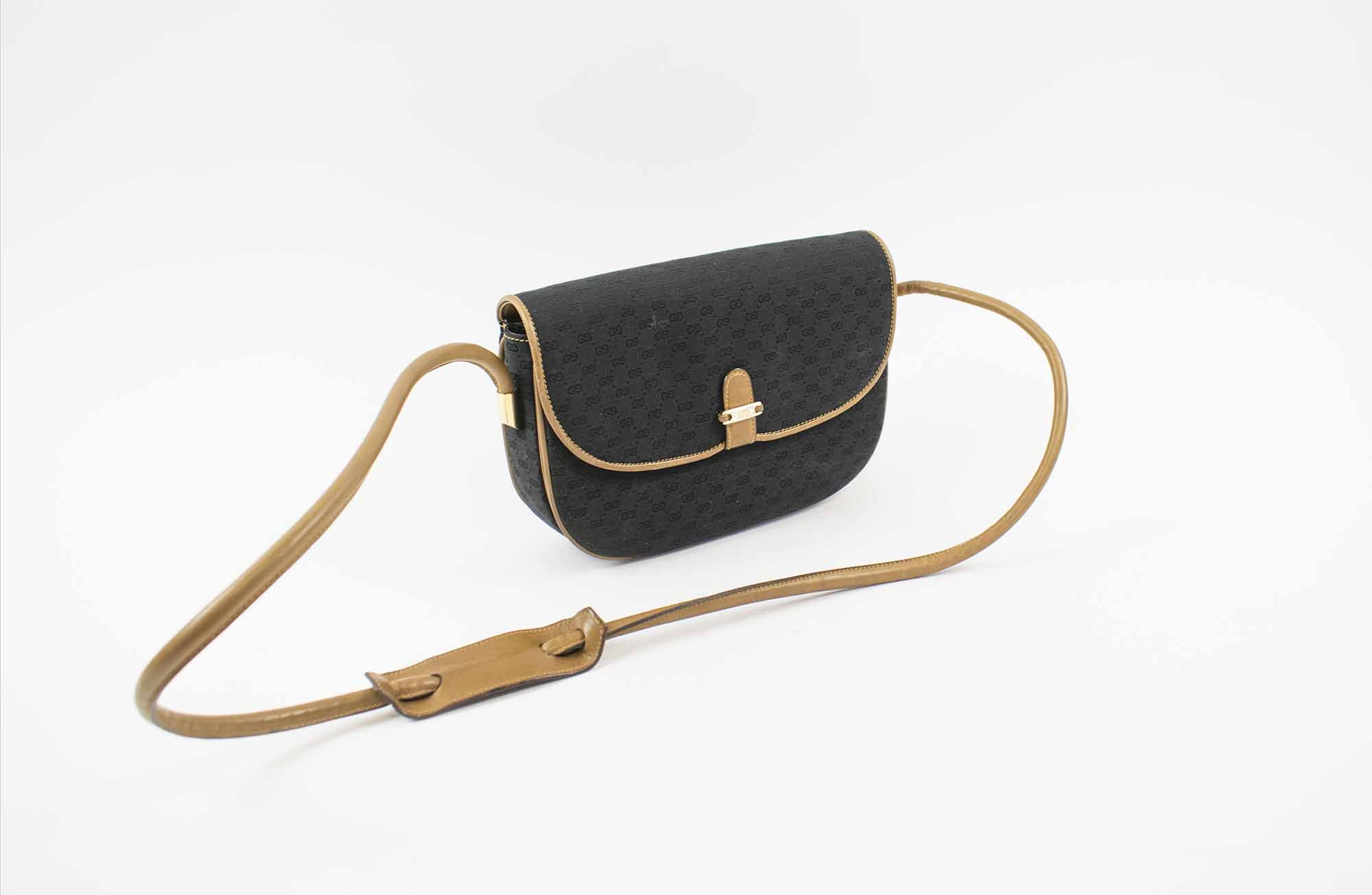 GUCCI VINTAGE CROSSBODY/SHOULDER BAG, black monogram fabric with leather  natural strap and trims, gold tone hardware and logo plaque at the front,  24cm x 17cm H x 7cm.