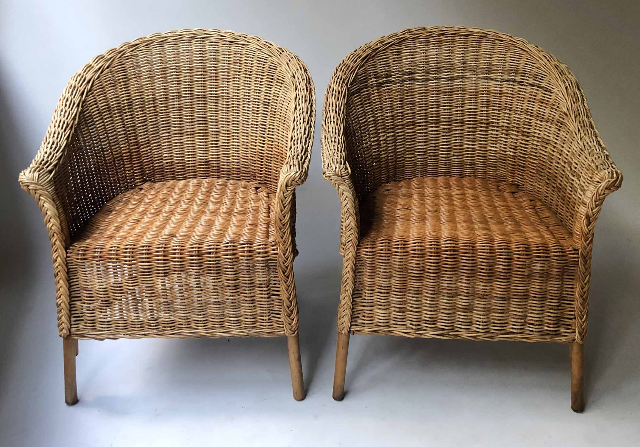 CANE ARMCHAIRS, a pair, two tone cane with rounded backs and arched